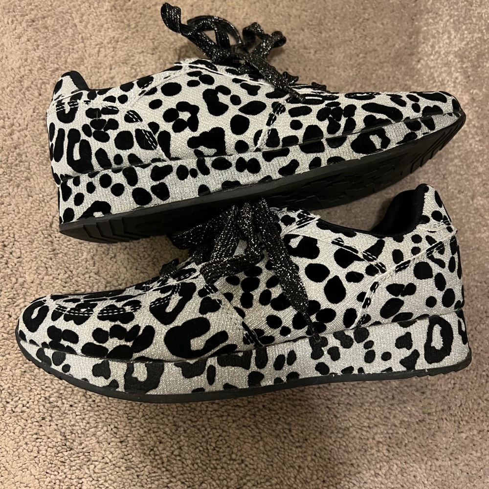 Silver and black leopard print shoes. They have a sparkle to them.